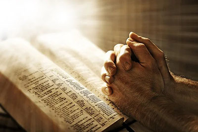 photo-praying-over-a-bible-400x267